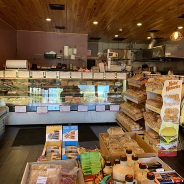 Interior of Cogman’s Creek butcher shop with display cases of meat and shelves of packaged goods.